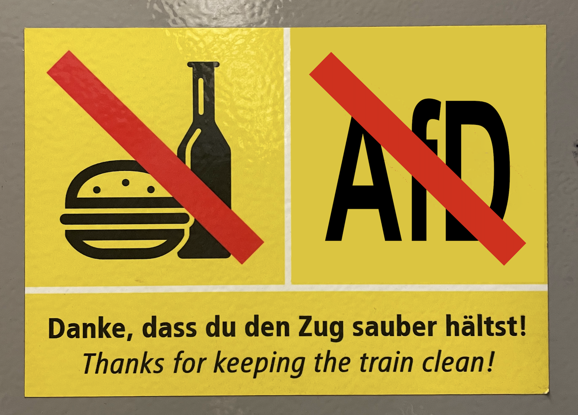 A subway sign showing a crossed-out name of the right-wing German AfD party.